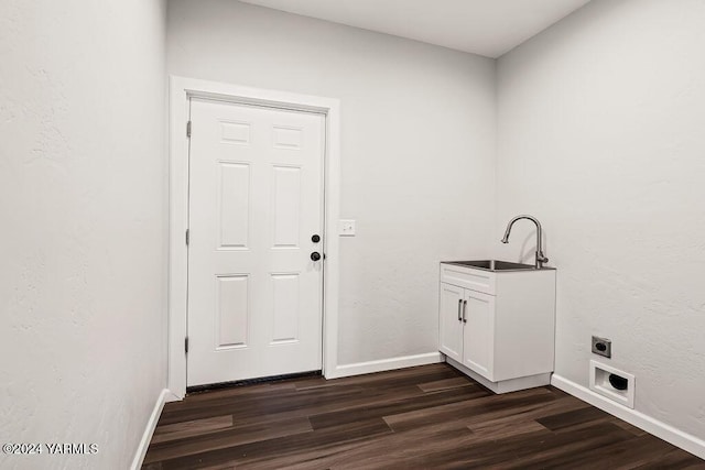 laundry room featuring cabinet space, baseboards, dark wood-style flooring, electric dryer hookup, and a sink