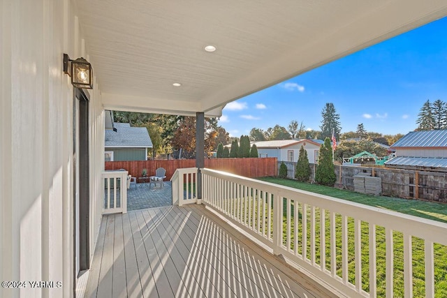 wooden deck featuring a fenced backyard and a yard