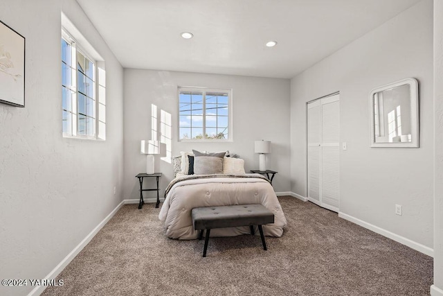 carpeted bedroom featuring recessed lighting, a closet, and baseboards