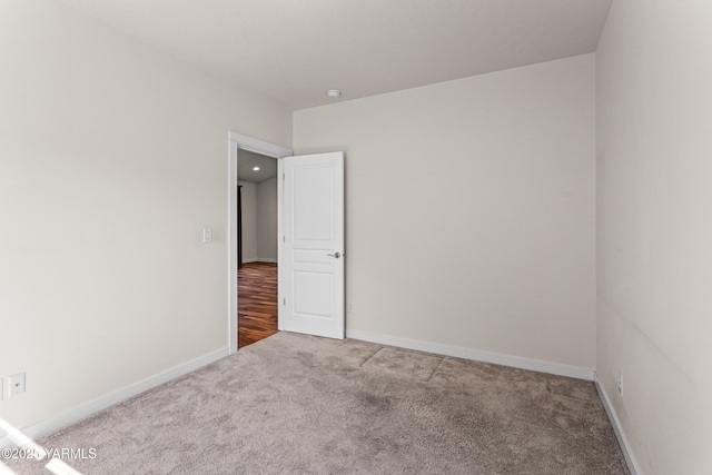 empty room with carpet flooring and baseboards