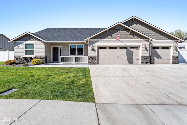 craftsman inspired home featuring stone siding, concrete driveway, a porch, and an attached garage