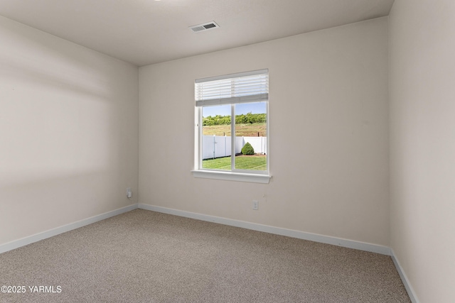 empty room featuring carpet flooring and baseboards