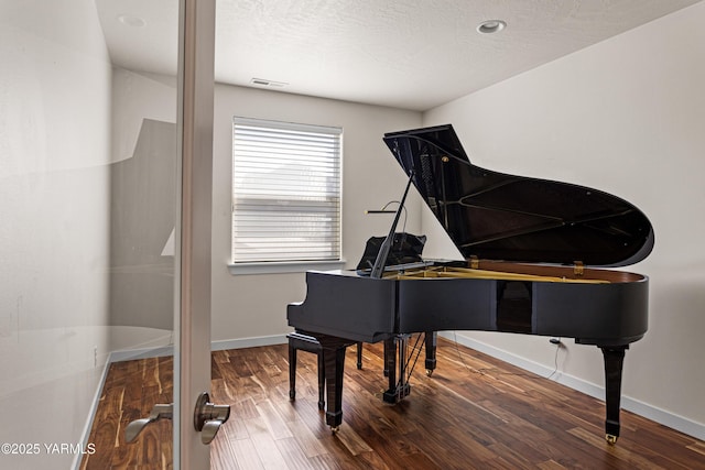 living area with wood finished floors and baseboards