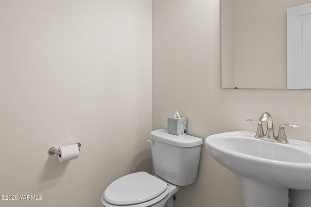 bathroom with toilet and a sink