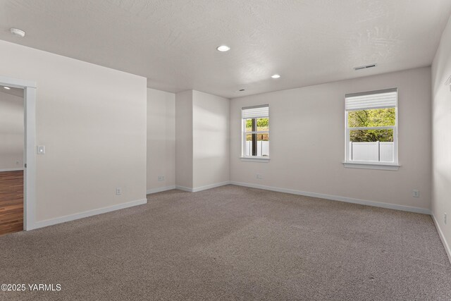 unfurnished room featuring carpet floors, baseboards, recessed lighting, and a smoke detector