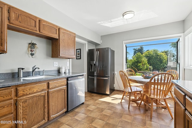 702 S 31st Ave, Yakima, WA 98902 - kitchen with appliances with stainless steel finishes, brown cabinetry, and dark countertops