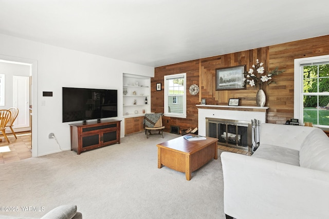 702 S 31st Ave, Yakima, WA 98902 - living area featuring wood walls, plenty of natural light, a fireplace, carpet, and built in features