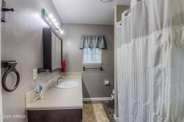 full bath featuring toilet, a shower with shower curtain, vanity, baseboards, and tile patterned floors