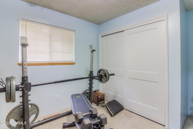 workout room featuring a textured ceiling