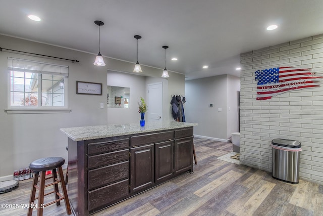 bar with recessed lighting, wood finished floors, and pendant lighting