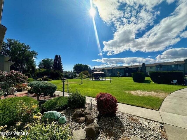 view of community featuring a yard and a gazebo