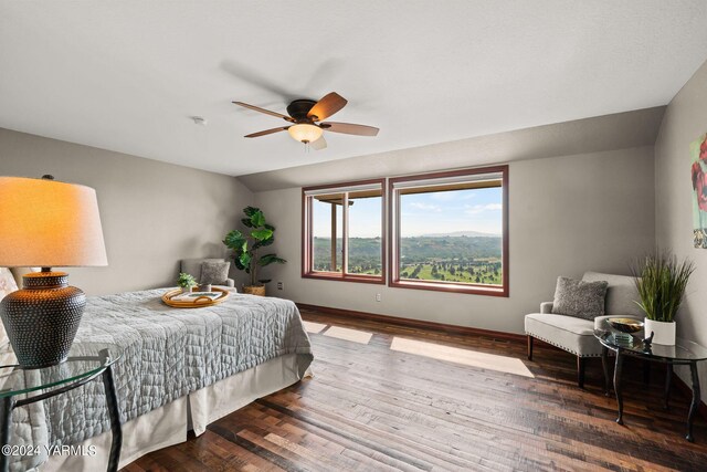 bedroom with lofted ceiling, ceiling fan, baseboards, and wood finished floors