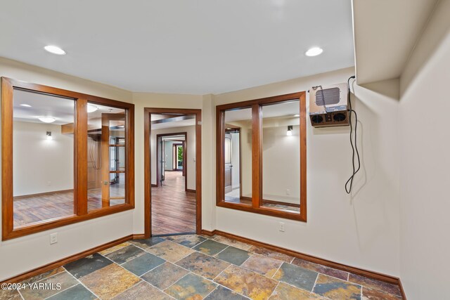 spare room with recessed lighting, stone tile flooring, and baseboards