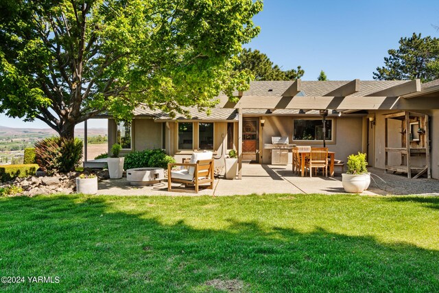 rear view of house with a patio, a yard, area for grilling, and stucco siding