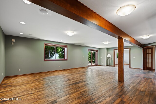 interior space with baseboards, beamed ceiling, dark wood-style flooring, and french doors