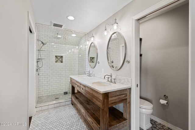 full bath featuring toilet, a sink, visible vents, and a shower stall