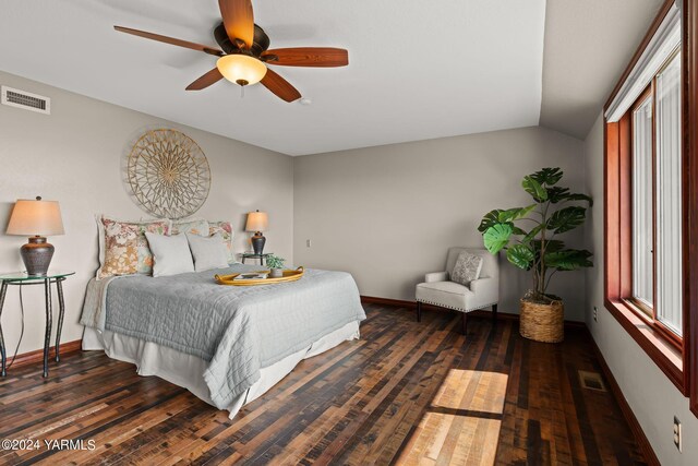 bedroom featuring lofted ceiling, dark wood-style floors, baseboards, and visible vents