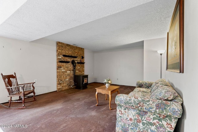 carpeted living area featuring a wood stove and a textured ceiling