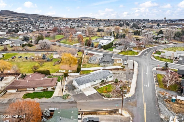 drone / aerial view featuring a residential view and a mountain view