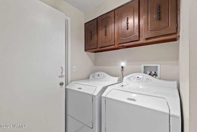 clothes washing area with cabinet space and washing machine and clothes dryer