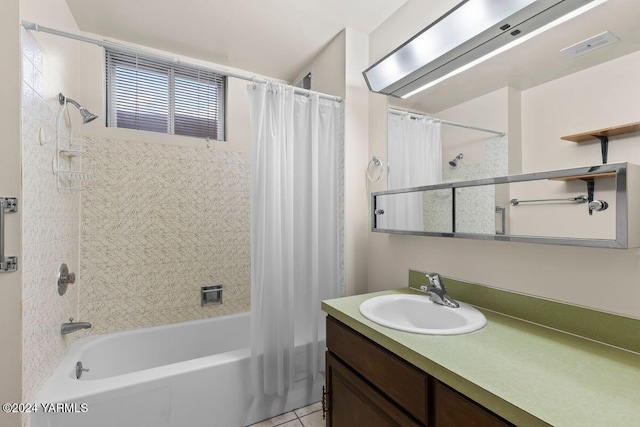 full bath with visible vents, tile patterned flooring, shower / bath combo with shower curtain, and vanity