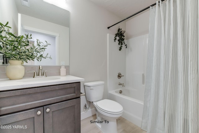 607 Vineyard Street (Phase 2Lot 25) Spec, Grandview, WA 98930 - full bath with shower / tub combo with curtain, toilet, vanity, wood finished floors, and decorative backsplash