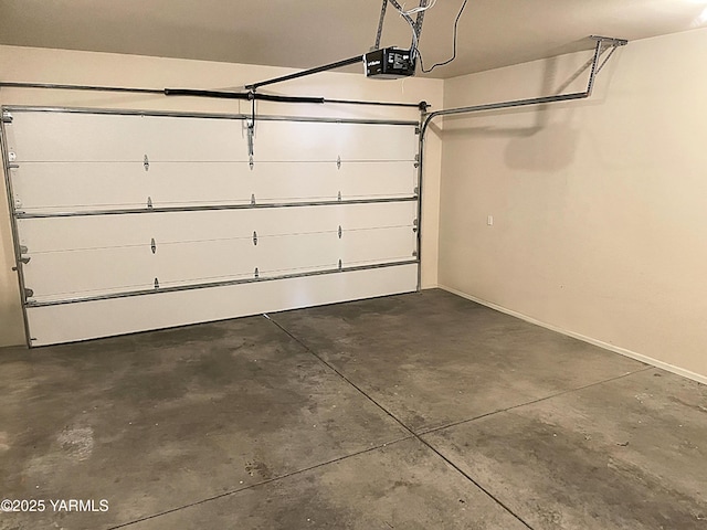 garage with baseboards and a garage door opener