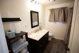 full bathroom featuring wood finished floors, vanity, and toilet