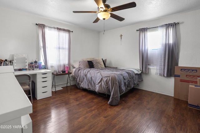 bedroom with ceiling fan, a textured ceiling, and wood finished floors