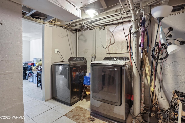 laundry room with light tile patterned floors, independent washer and dryer, and laundry area