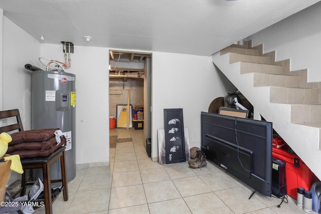 basement featuring tile patterned floors and water heater