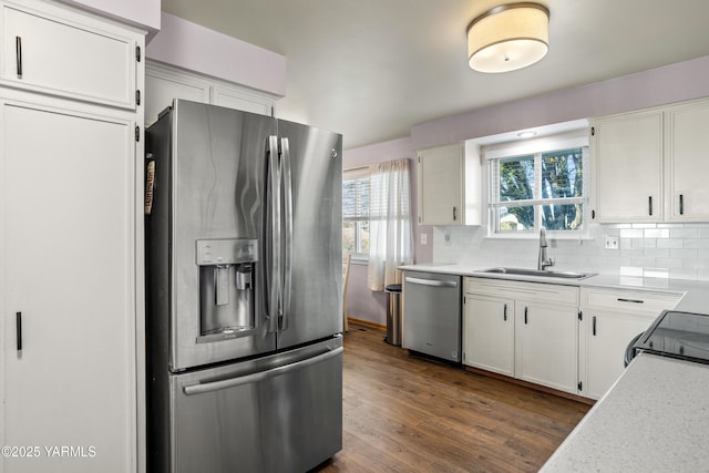 607 N 53rd Ave, Yakima, WA 98908 - kitchen with stainless steel appliances, dark wood finished floors, white cabinets, light countertops, and decorative backsplash