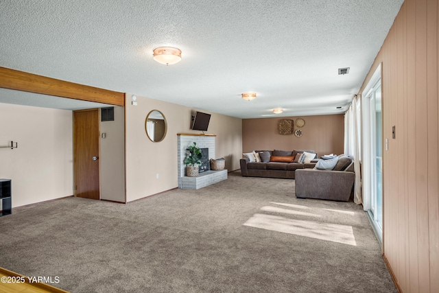 607 N 53rd Ave, Yakima, WA 98908 - living area featuring carpet, a fireplace, and a textured ceiling