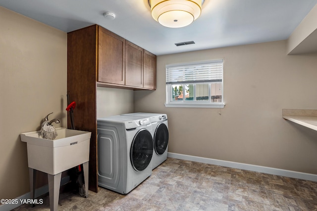 607 N 53rd Ave, Yakima, WA 98908 - laundry room featuring cabinet space, washing machine and clothes dryer, and stone finish floors