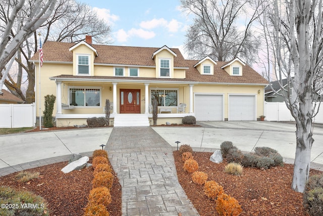 view of front of property featuring driveway, a shingled roof, an attached garage, fence, and a porch