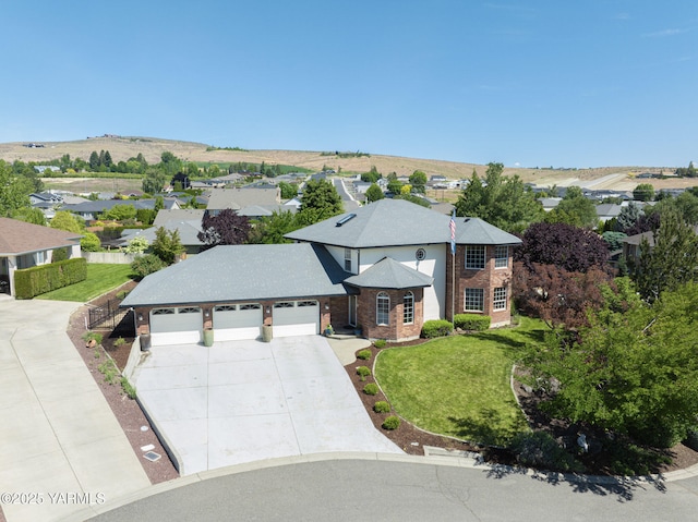 9203 W Yakima Ct, Yakima, WA 98908 - view of front facade with concrete driveway, a garage, a front lawn, and a residential view