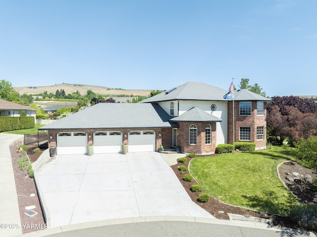 9203 W Yakima Ct, Yakima, WA 98908 - view of front of property with driveway, brick siding, and a garage