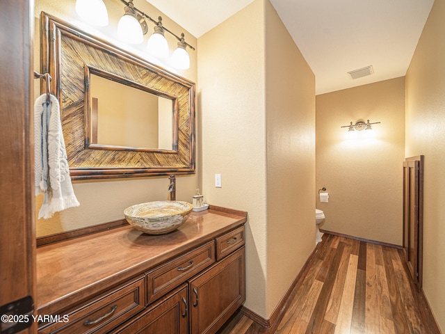 9203 W Yakima Ct, Yakima, WA 98908 - bathroom with wood finished floors, toilet, vanity, and baseboards