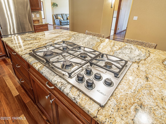 9203 W Yakima Ct, Yakima, WA 98908 - kitchen view of appliances with stainless steel finishes, light stone countertops, and dark wood-type flooring