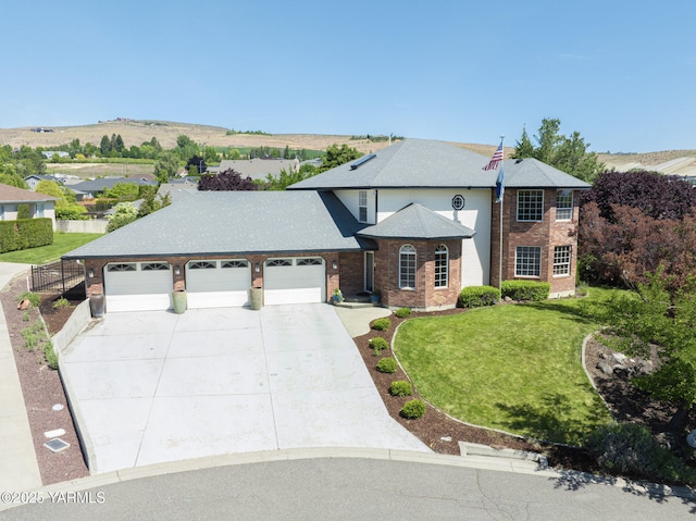 9203 W Yakima Ct, Yakima, WA 98908 - traditional home featuring a garage, brick siding, and driveway