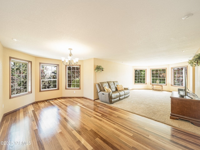 9203 W Yakima Ct, Yakima, WA 98908 - living room featuring a chandelier, wood finished floors, a textured ceiling, and baseboards