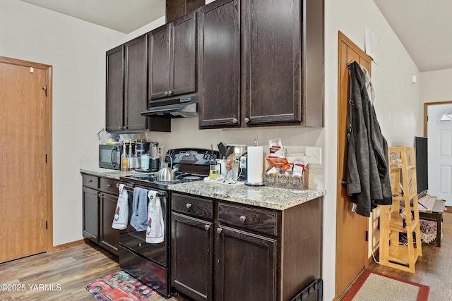3103 Swan Ave, Yakima, WA 98902 - kitchen with black appliances, under cabinet range hood, light wood finished floors, and dark brown cabinets