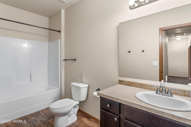 3103 Swan Ave, Yakima, WA 98902 - bathroom with vanity, toilet, wood finished floors, washtub / shower combination, and baseboards