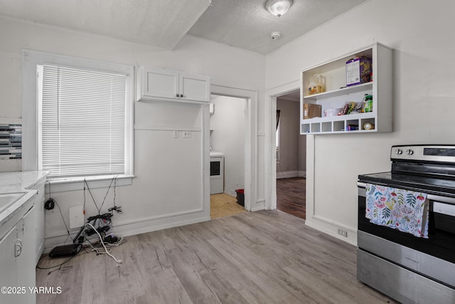204 S 8th St, Yakima, WA 98901 - kitchen featuring electric range, light wood-type flooring, white cabinets, open shelves, and light countertops