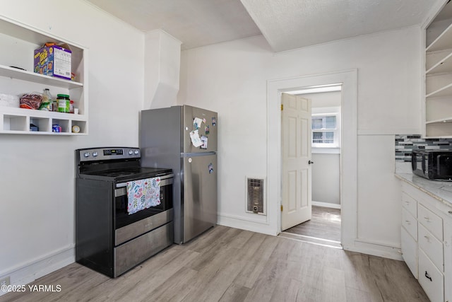 204 S 8th St, Yakima, WA 98901 - kitchen featuring open shelves, stainless steel appliances, light wood-style flooring, white cabinets, and heating unit