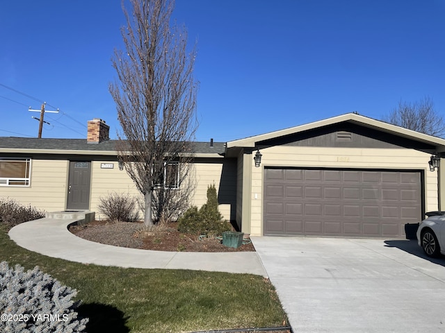 single story home with a garage, driveway, and a chimney