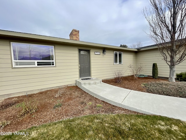 single story home with a chimney