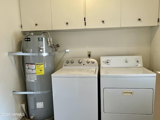 laundry room with strapped water heater, cabinet space, and washing machine and clothes dryer