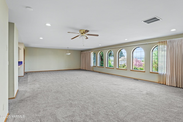 spare room with visible vents, recessed lighting, and a healthy amount of sunlight