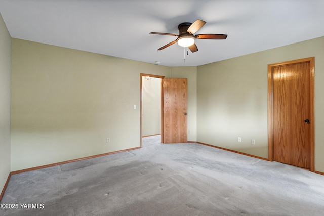 unfurnished room with carpet flooring, ceiling fan, and baseboards